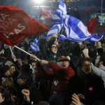 Supporters of radical leftist Syriza party chant slogans and wave Greek national and other flags after winning elections in Athens