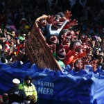 A carnival float with a papier-mache caricature drives past revellers during the traditional Rose Monday carnival parade in Duesseldorf