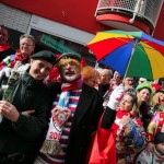 Carnival revellers pose with police officer during Rose Monday carnival parade in Duesseldorf