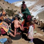 Berber women wash a child in Ait Sghir village in the High Atlas region of Morocco