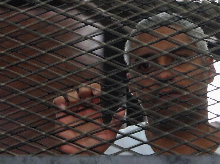 File photo of Al Jazeera journalist Mohamed Fahmy behind bars at a court in Cairo