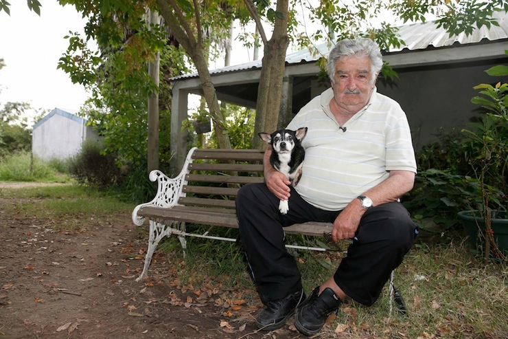 Uruguay's President Mujica pose for picture with dog Manuela after interview with Reuters in farm in outskirts of Montevideo
