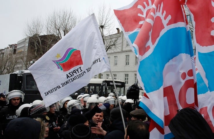 Supporters of the Turkish left-wing Freedom and Solidarity Party (ODP), march with a flag of Greece's ruling Syriza party during a protest against a G20 meeting in Istanbul