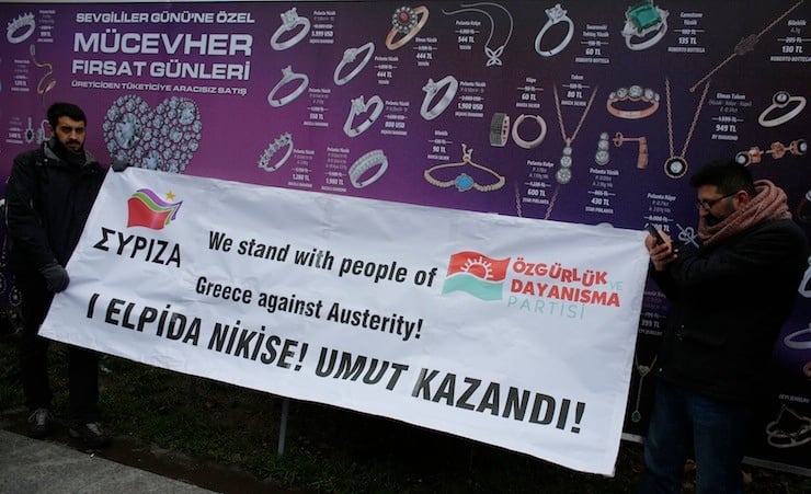 Supporters of the Turkish left-wing Freedom and Solidarity Party (ODP), hold a banner in favour of Greece's ruling Syriza party, during a protest against a G20 meeting in Istanbul