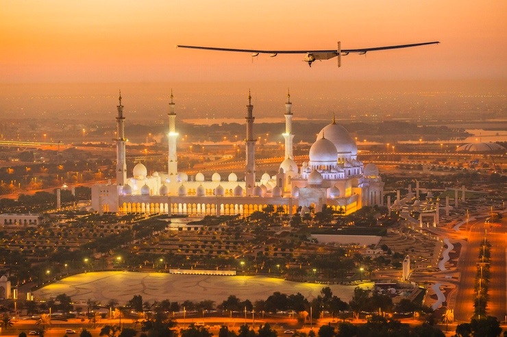 The Solar Impulse 2, a solar-powered plane, flies over the Sheikh Zayed Grand Mosque in Abu Dhabi