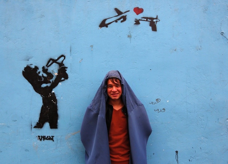 A male Afghan women's rights activist poses for pictures in burqa to show solidarity to Afghan women ahead of International Women's Day in Kabul