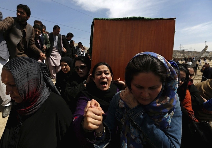 Afghan women's rights activists carry the coffin of Farkhunda, an Afghan woman who was beaten to death and set alight on fire on Thursday, during her burial ceremony in Kabul