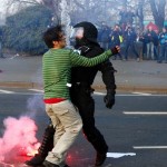 A policeman stops a 'Blockupy' anti-capitalist protester near the ECB building before the official opening of its new headquarters in Frankfurt