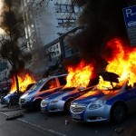 Four German police cars set on fire by anti-capitalist protesters burn near the new ECB headquarters in downtown Frankfurt