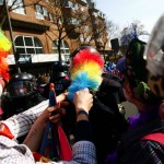 Anti-capitalist protesters dressed as clowns gesture in front of a policeman near the ECB building before the official opening of its new headquarters in Frankfurt