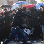 A protester throws a stone during riots with police near the new European Central Bank (ECB) headquarters in Frankfurt