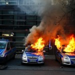 German police cars set on fire by anti-capitalist protesters burn near the new ECB headquarters in downtown Frankfurt