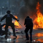 A policeman stops a 'Blockupy' anti-capitalist protester near the ECB building before the official opening of its new headquarters in Frankfurt