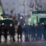 German policemen are seen through the heat haze of a burning barricade during a protest of members of 'Blockupy' anti-capitalist movement near the ECB building before the official opening of its new headquarters in Frankfurt