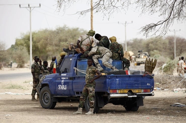 Chadian soldiers sit in a military pickup truck in Damasak