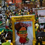 Demonstrator holds a sign with an image depicting Brazil's President Dilma Rousseff during a protest against Rousseff at Paulista avenue in Sao Paulo