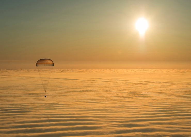 The Soyuz TMA-14M capsule with ISS crew members Barry Wilmore of the U.S., Alexander Samokutyaev and Elena Serova of Russia is seen above clouds as it descends before landing southeast of Dzhezkazgan