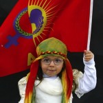 A Kurdish girl poses for a picture as she arrives for a gathering celebrating Newroz in Diyarbakir