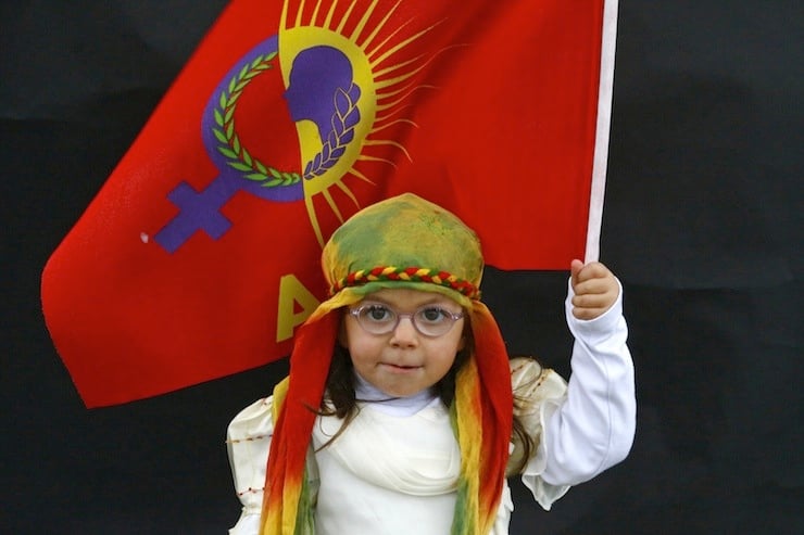 A Kurdish girl poses for a picture as she arrives for a gathering celebrating Newroz in Diyarbakir