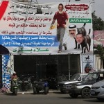 An anti-Brotherhood supporter and a supporter of Egypt's army sits in front his shop in Cairo