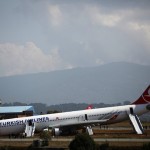 A Turkish Airlines plane lies on a field after it overshot the runway at Tribhuvan International Airport in Kathmandu