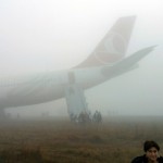 Passengers exit from a Turkish Airlines plane soon after it overshot from the runway in Kathmandu