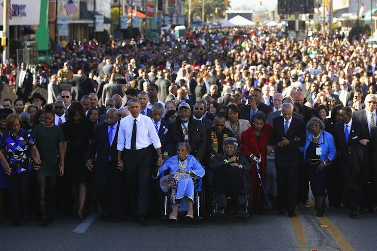 Obama participates in a march across the Edmund Pettus Bridge in Selma, Alabama