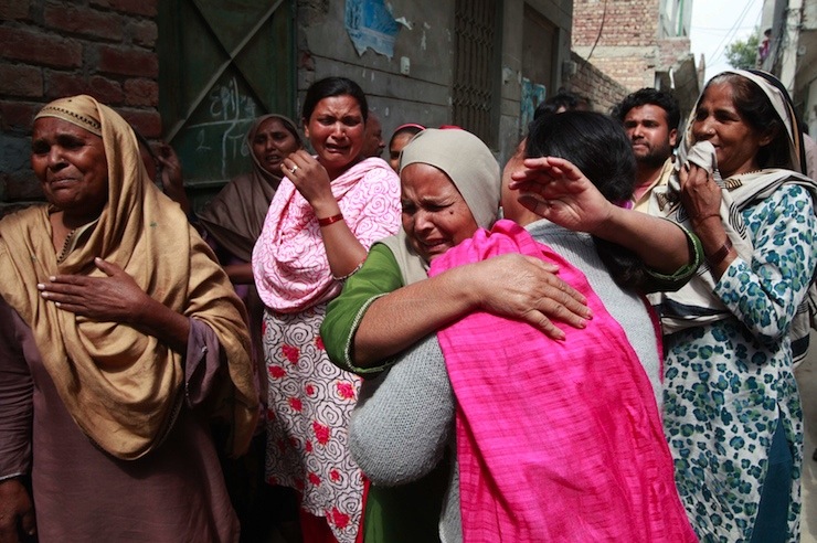 Women mourn the death of their relative who was killed in a suicide attack on a church in Lahore