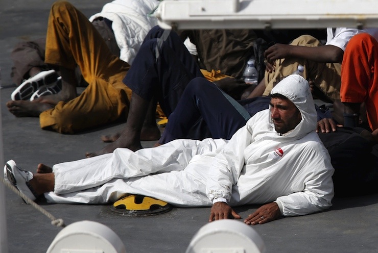 Mohammed Ali Malek, one of two survivors of Saturday's migrant boat disaster, later arrested on suspicion of people trafficking, is seen watching bodies of dead migrants being disembarked from the Italian coastguard ship Bruno Gregoretti in Senglea
