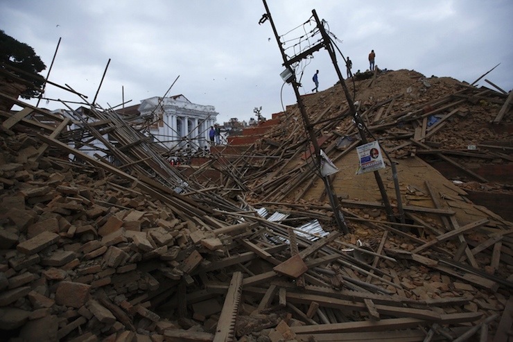 People work to rescue trapped people inside a temple in Bashantapur Durbar Square after an earthquake hit, in Kathmandu