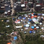 Red Cross handout picture of tents set up in an open area near multi-storey buildings following an earthquake in Kathmandu