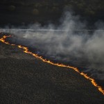 An aerial view from a helicopter shows fire on the ground in northern Ukraine