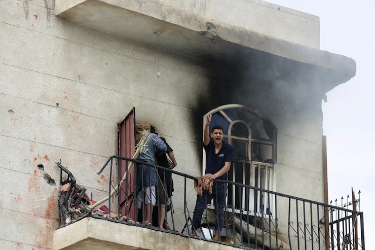A man reacts at the site of an air strike in Sanaa
