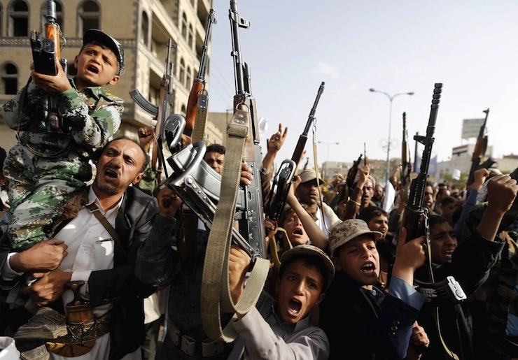 Boys supporting the Houthi group hold up rifles as they shout slogans during a demonstration against the air strikes by the Saudi-led coalition in Sanaa