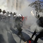 Anti-establishment protesters clash with riot police during a protest against high security prisons in Athens