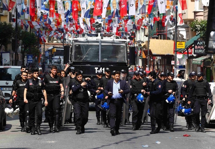 Policemen block a street to prevent people from gathering for May Day demonstrations near Taksim Square in Istanbul