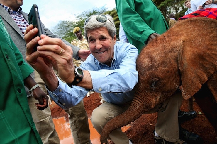 U.S. Secretary of State John Kerry takes a selfie with a baby elephant while touring the Sheldrick Center Elephant Orphanage at the Nairobi National Park