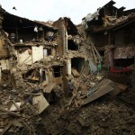 People search for family members trapped inside collapsed houses a day after an earthquake in Bhaktapur