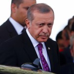 Turkish President Erdogan looks on after arriving at Esenboga Airport in Ankara