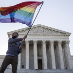 File photo of Vin Testa waving a gay rights flag in front of the Supreme Court before a hearing about gay marriage in Washington