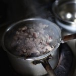 A chef cooks dog meat at a dog meat restaurant ahead of local dog meat festival in Yulin