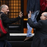 Greek Finance Minister Varoufakis and Interior Minister Voutsis greet each other as they arrive at PM Tsipras' office at Maximos Mansion in Athens, Greece
