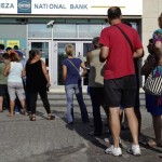 People line up to withdraw cash from an ATM outside a National Bank branch in Iraklio on the island of Crete, Greece