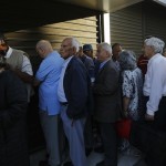Dozens of pensioners line up outside a branch of the National Bank of Greece hoping to get their pensions, in Athens