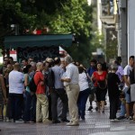 People line up at an ATM in Athens
