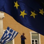 File photo of a protester waving a Greek flag at the entrance of the parliament building during a rally in Athens