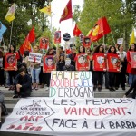 Members of the Kurdish community in France hold posters depicting victims of a Monday's bomb attack in Turkey during a demonstration in Paris