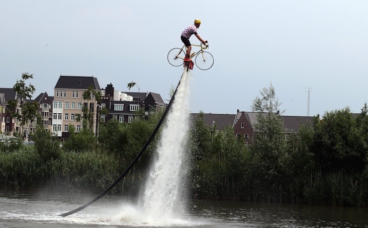 A man wearing a Tour de France best climber's jersey practises flyboarding before the start of the 166-km second stage of the 102nd Tour de France cycling race from Utrecht to Zeeland