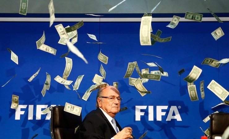 Banknotes are thrown at FIFA President Blatter as he arrives for a news conference after the Extraordinary FIFA Executive Committee Meeting at the FIFA headquarters in Zurich