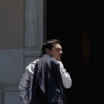 Greek PM Tsipras looks on as he arrives at this office at Maximos Mansion in Athens